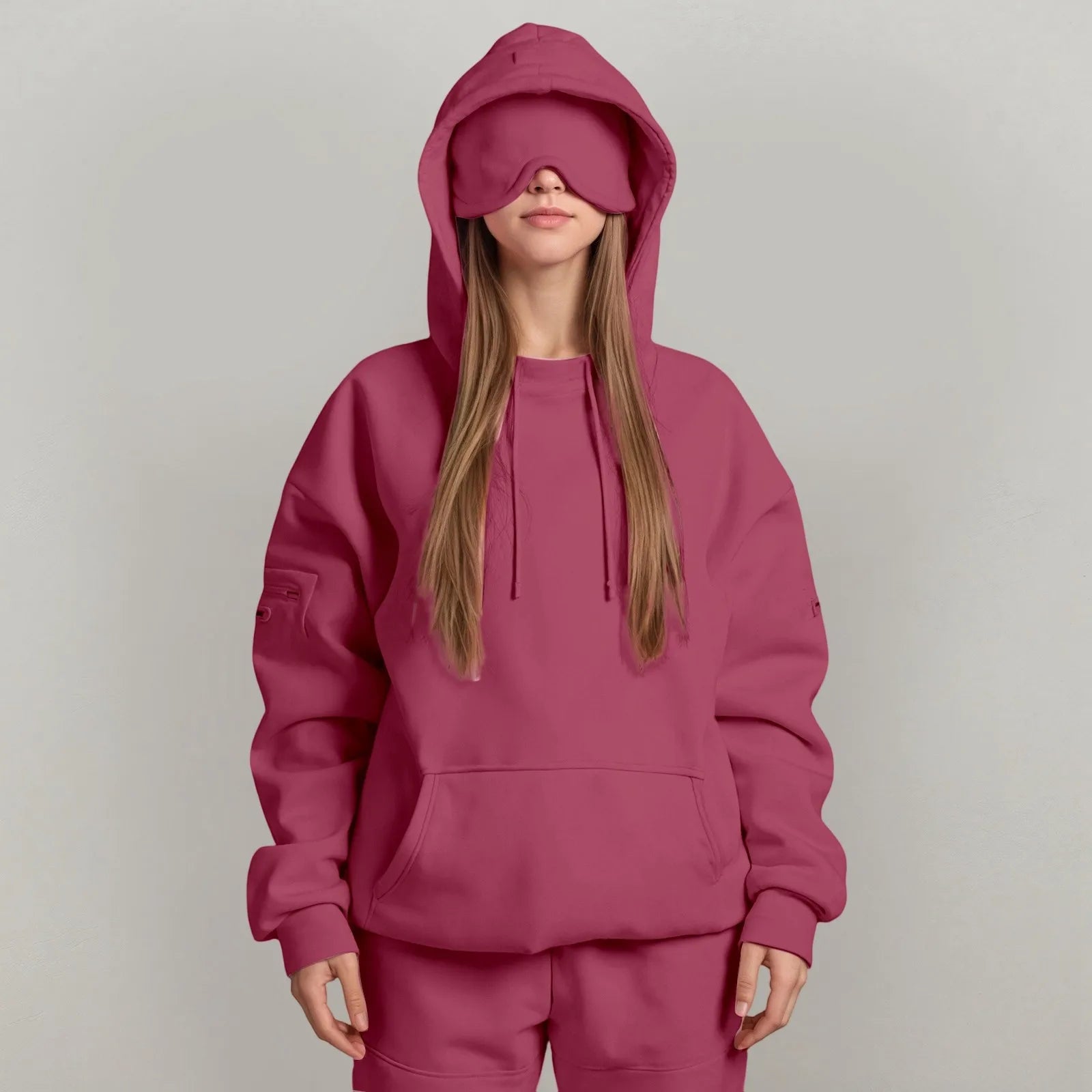 Person wearing a maroon hoodie and matching pants on a plain background