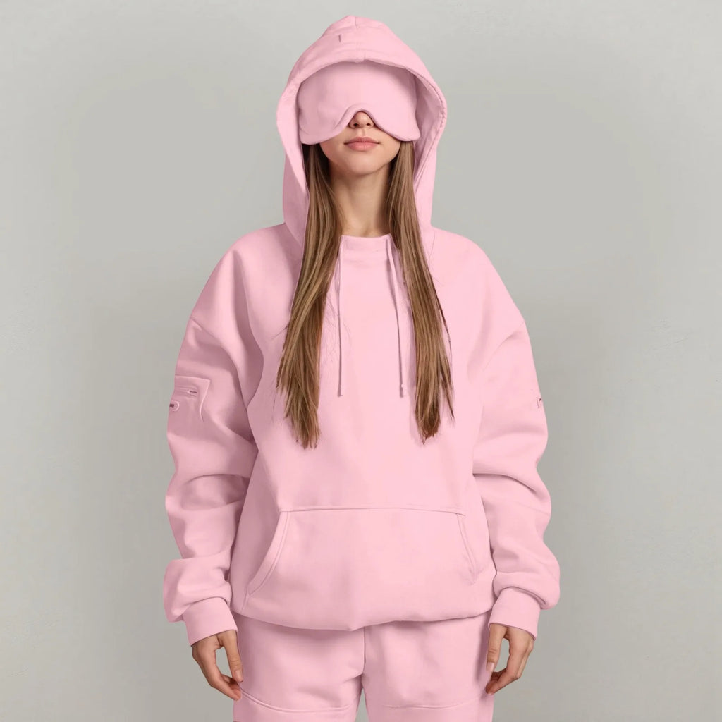 Blackout travel hood and eye mask for comfortable airplane sleep pink