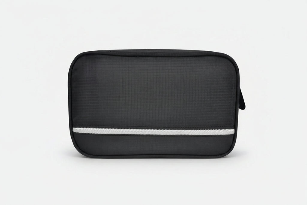 Black toiletry bag with a white stripe and 'Travelon' branding on a white background