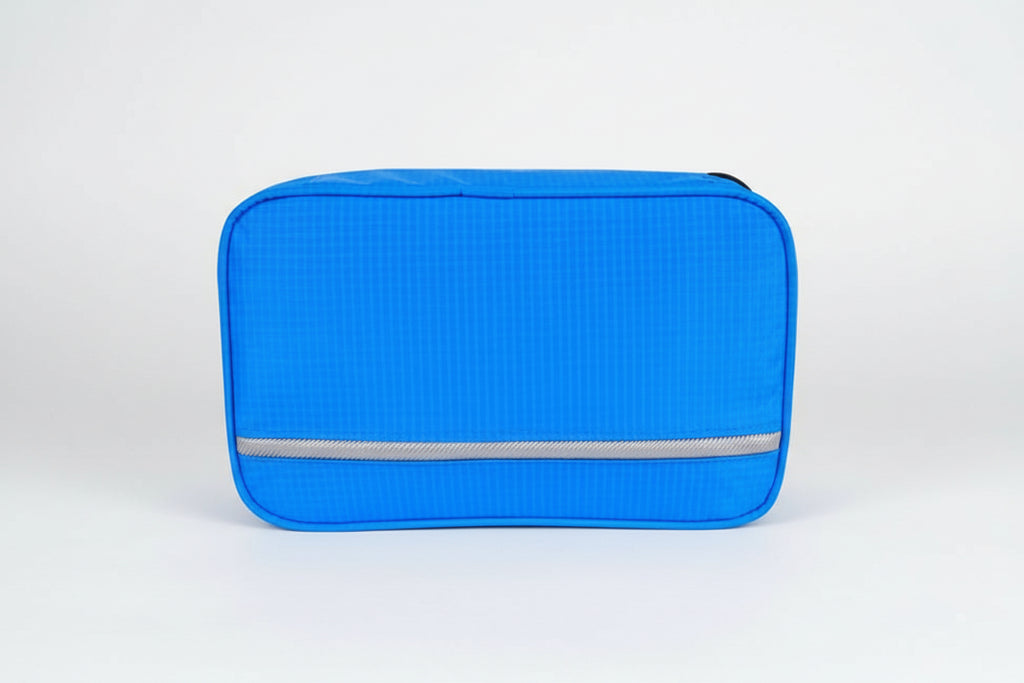 Blue travel pouch with a visible brand label on a white background
