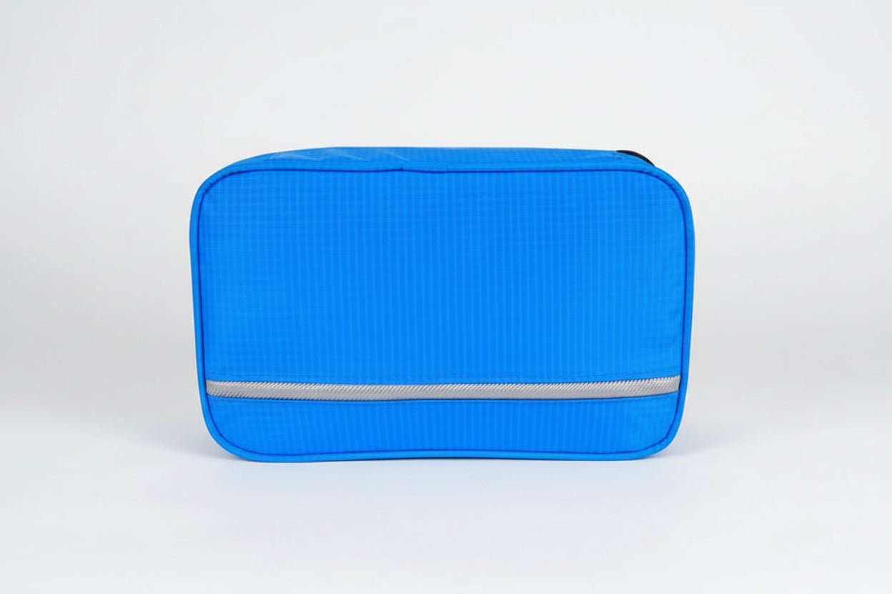 Blue travel pouch with a visible brand label on a white background