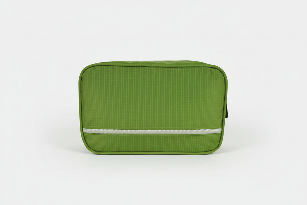 Green travel toiletry bag with a visible brand logo on a white background