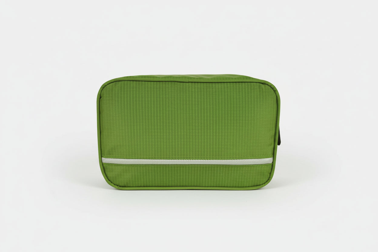 Green travel toiletry bag with a visible brand logo on a white background
