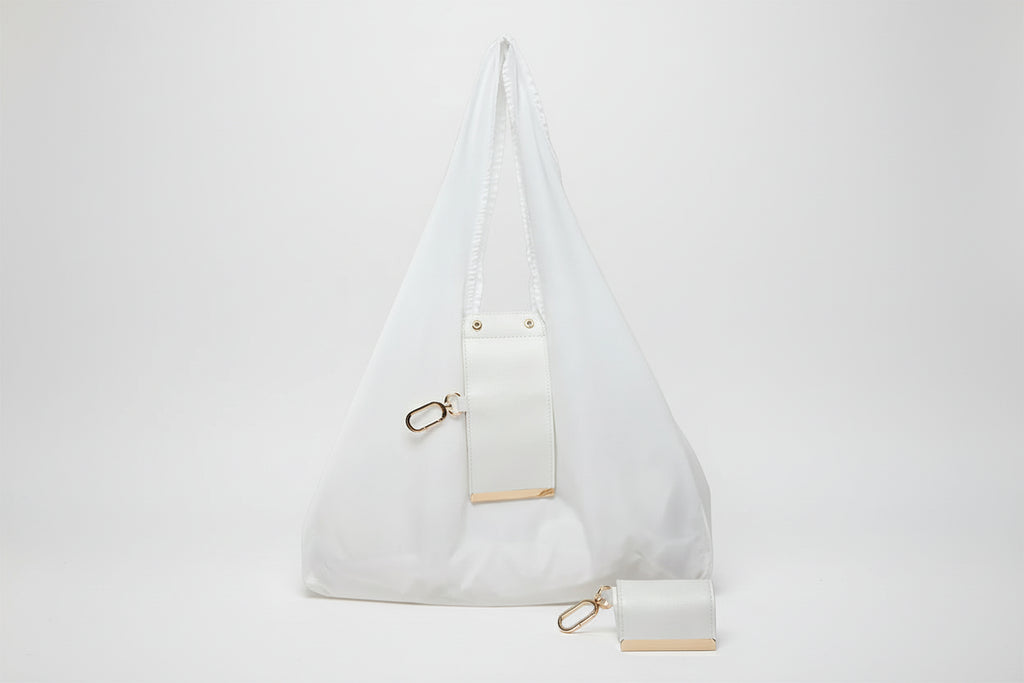 White handbag with gold accents on a white background