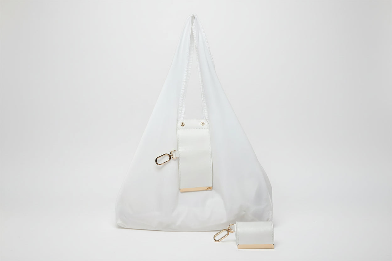 White handbag with gold accents on a white background