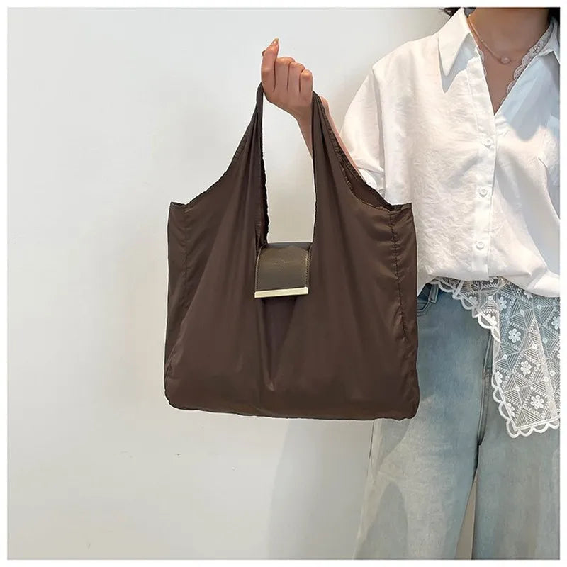 Person holding a brown bag with a white background