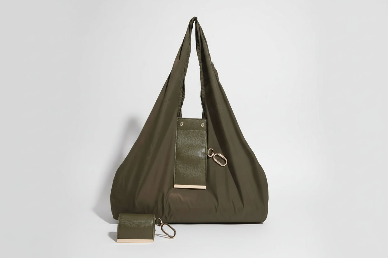 Green handbag with a pouch attached on a white background