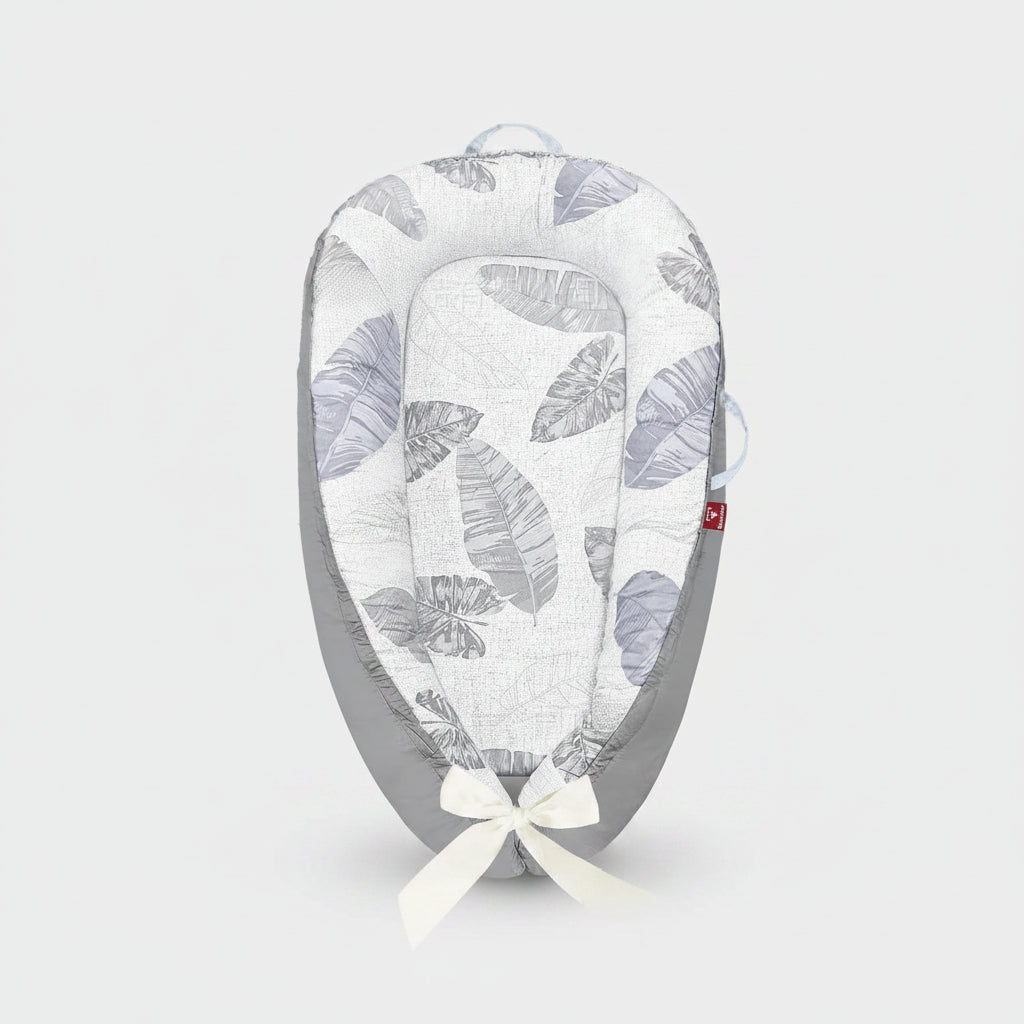 Baby nest with leaf pattern and packaging on a white background