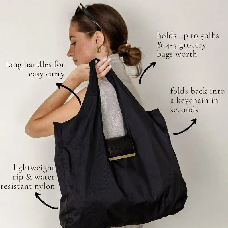 Woman holding a black reusable bag with text highlighting its features on a white background