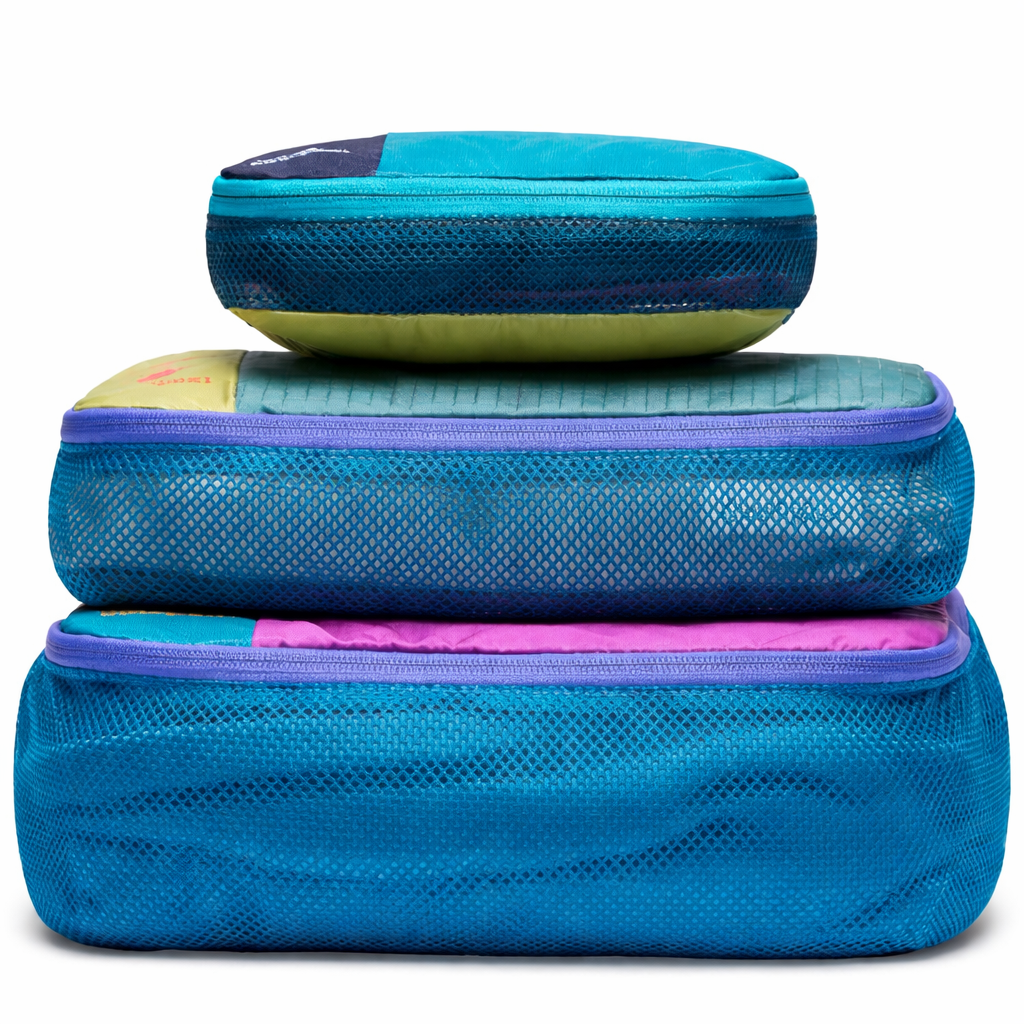 Three blue mesh packing cubes stacked - carry on travel accessories