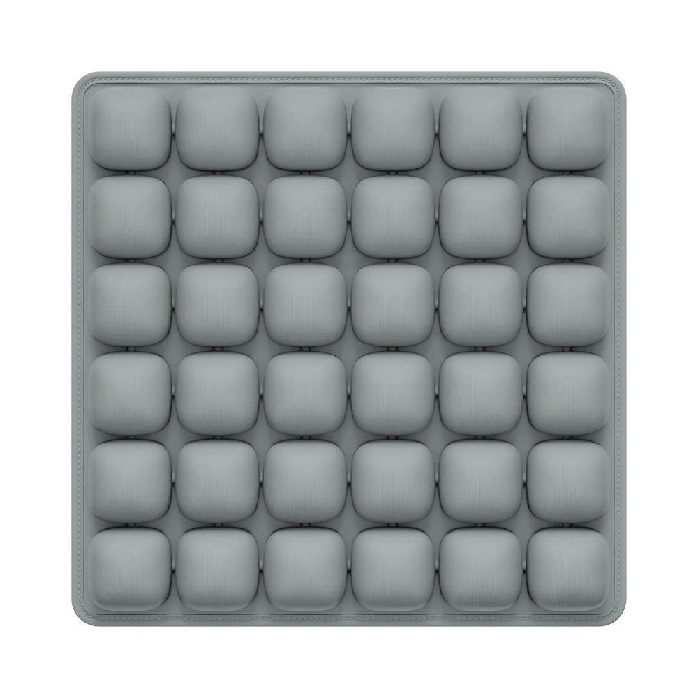 Gray silicone mold with multiple compartments on a white background
