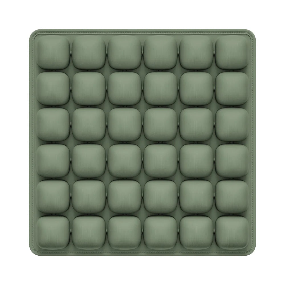 Green silicone mold with multiple compartments on a white background