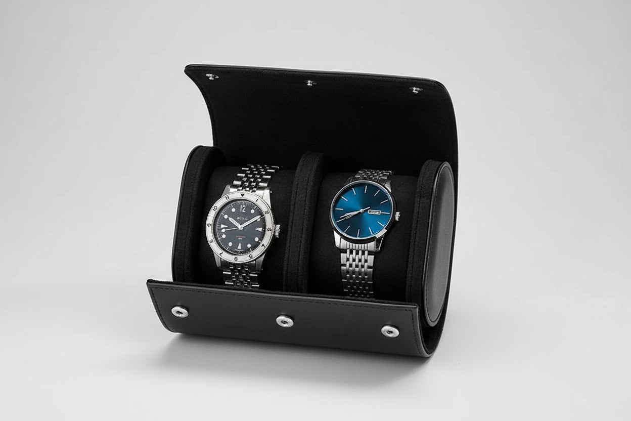 Two watches in a black watch holder on a gray surface