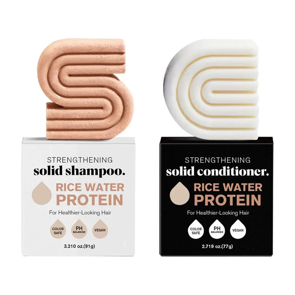 Product image of Two solid shampoo and conditioner bars with packaging on a white background front view 