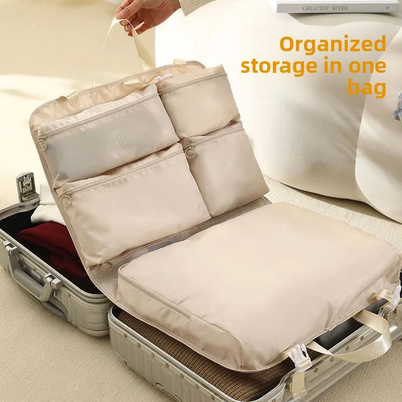 7-in-1 packing organiser open showing all compartments filled and organised inside suitcase