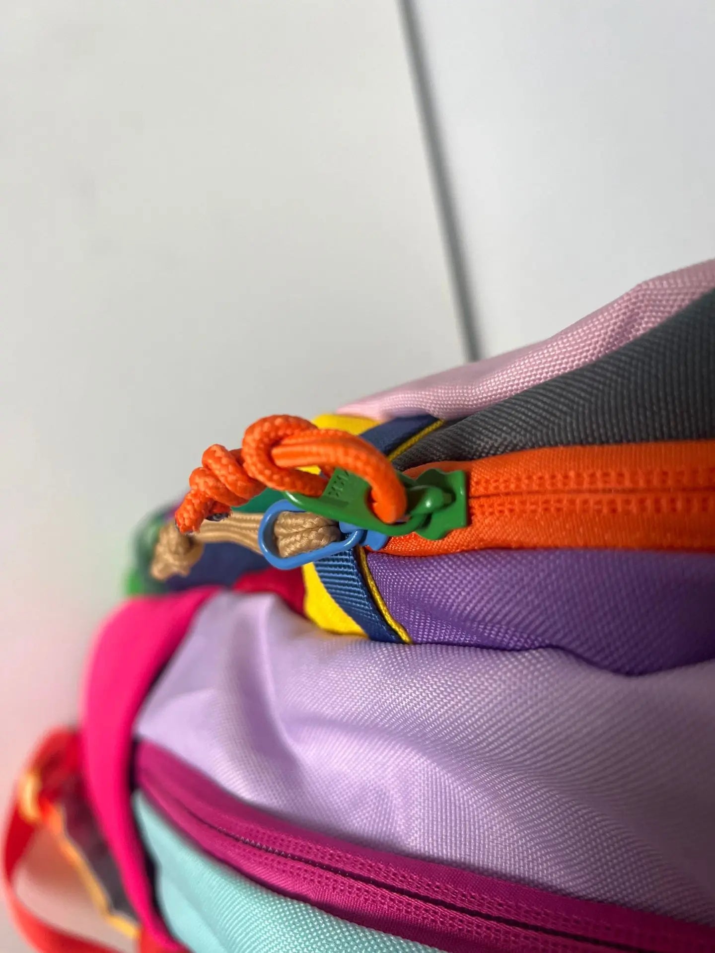 Colorful bag with a zipper and decorative elements - travel luggage