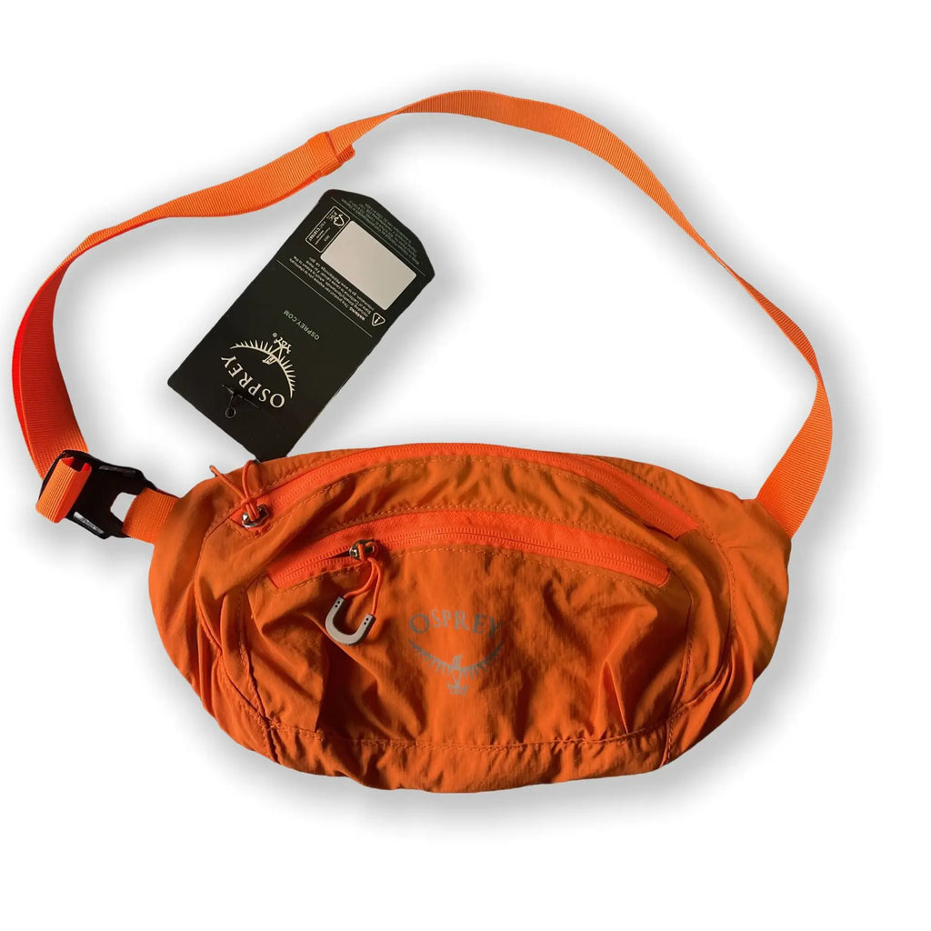 Orange waist bag with a visible brand tag - travel gear