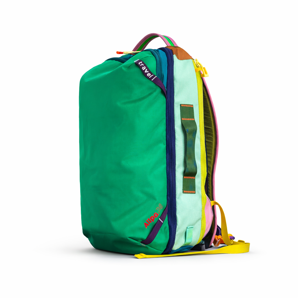 On white background of VibeTrail 28L colorful travel backpack front view green colour - travel gear