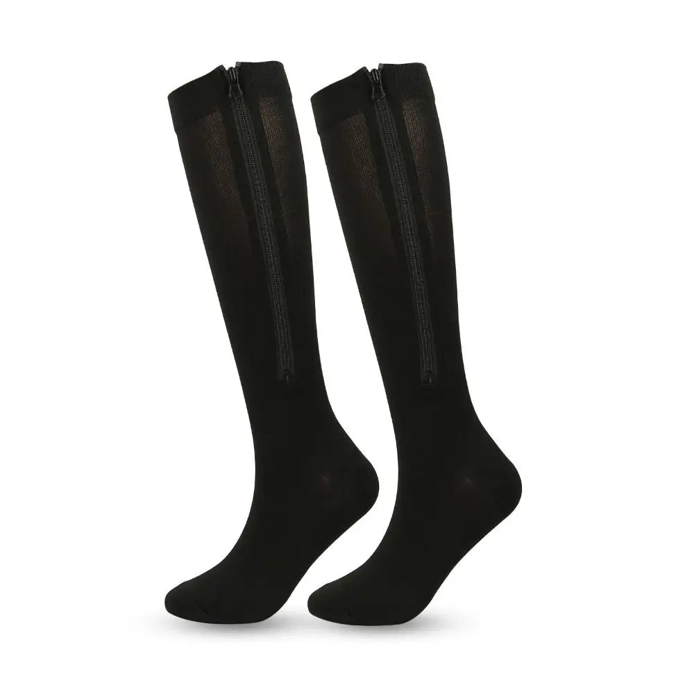 Pair of black knee-high socks with zippers on a white background