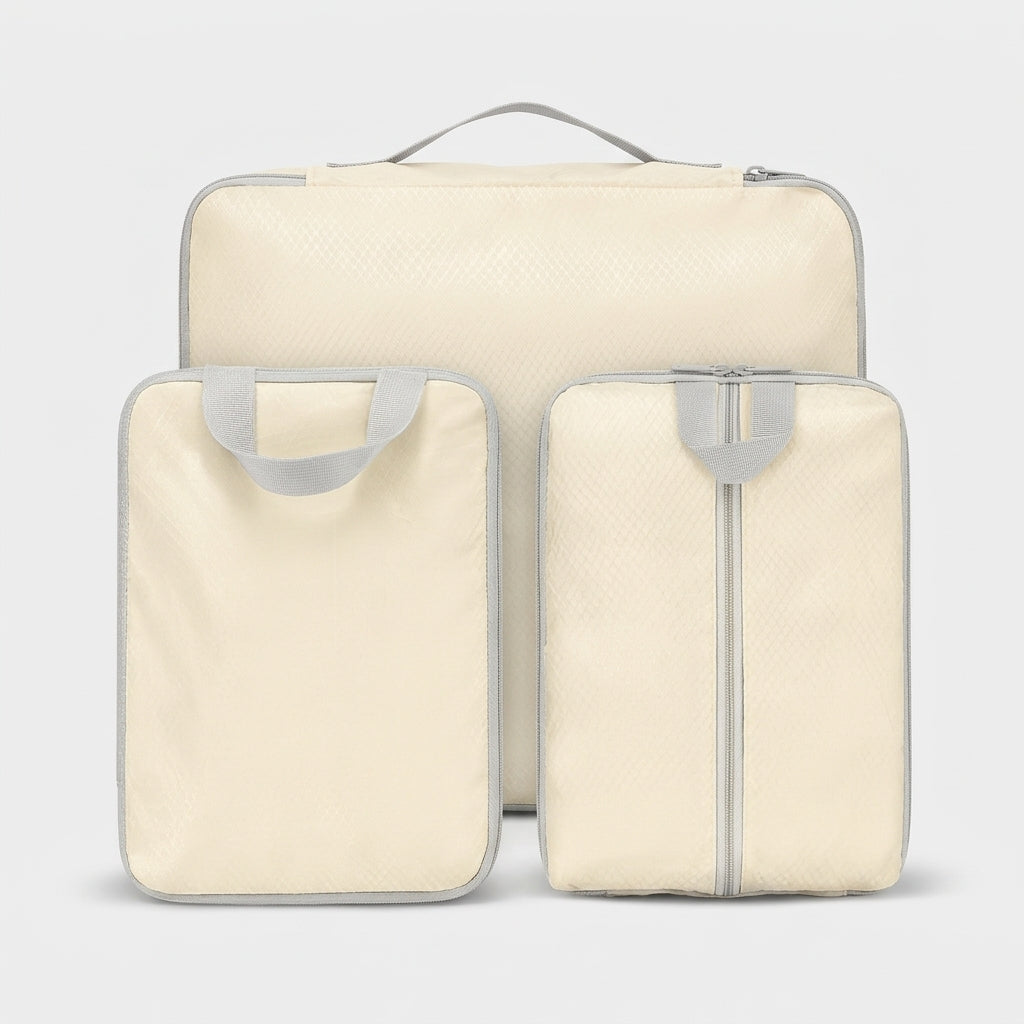 Compression packing cubes set in cream, three sizes with carry handles for travel organising