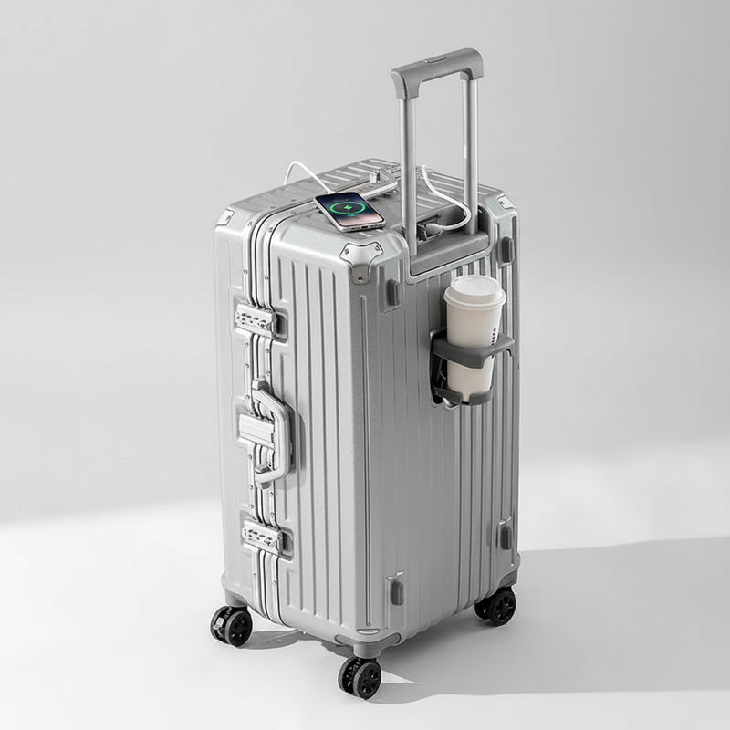 Silver suitcase with a smartphone on top against a beige background